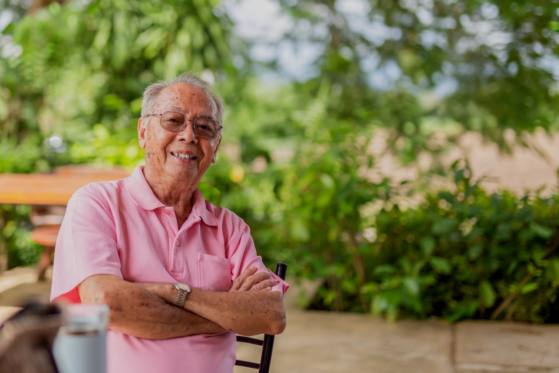 Portrait asian elderly man 83 years old with toothy smile sittin